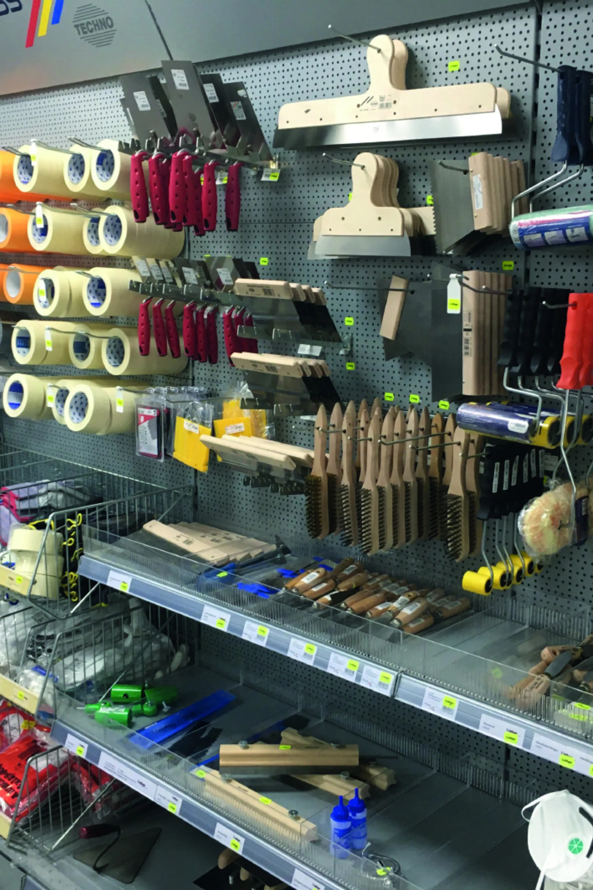 <think> Got it, let's create the alt text. The image shows a store shelf with various painting supplies. Need to describe wh…