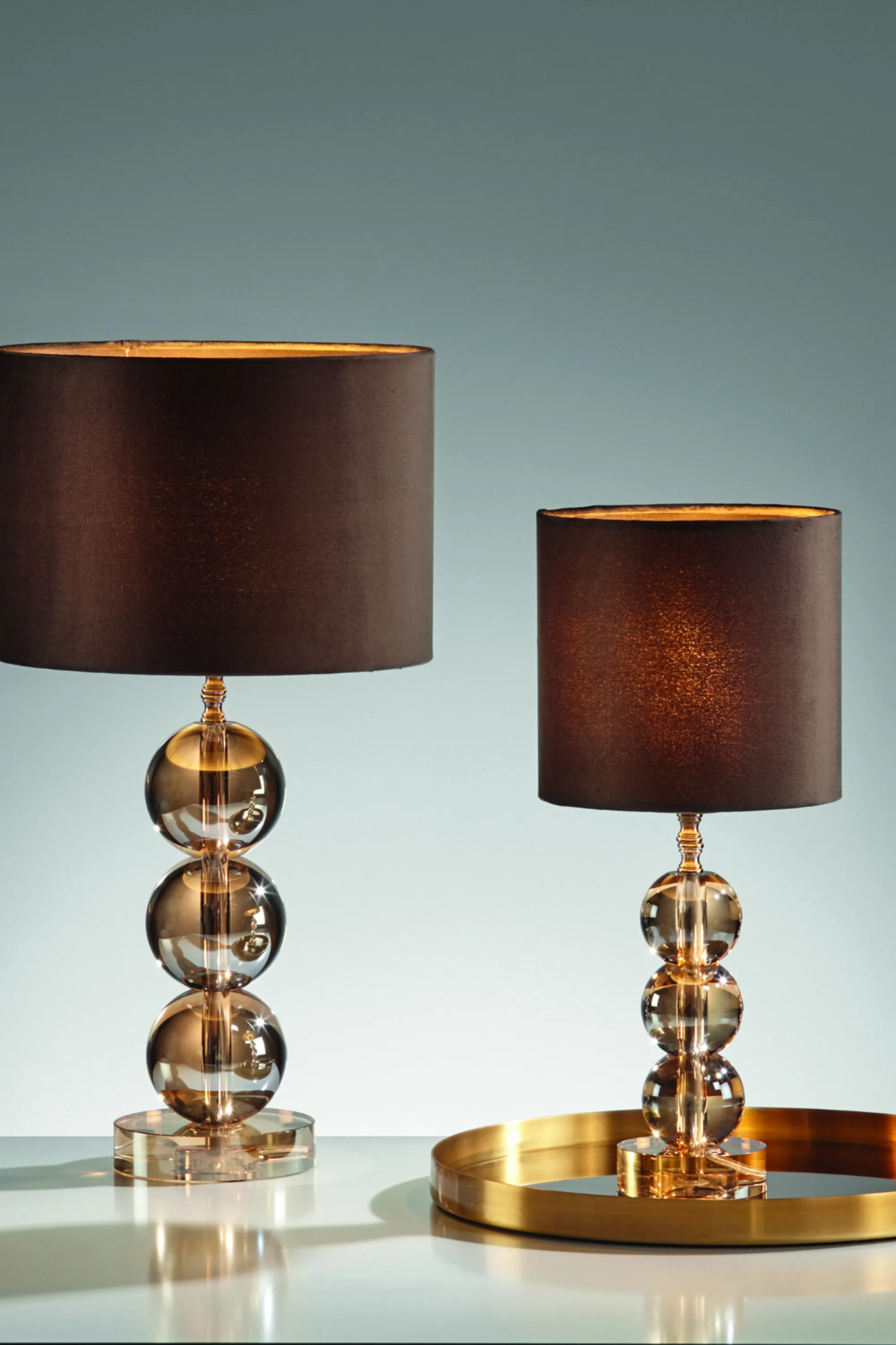 <think> Got it, let's create the alt text. First, look at the image: two table lamps with brown shades and glass ball bases.…