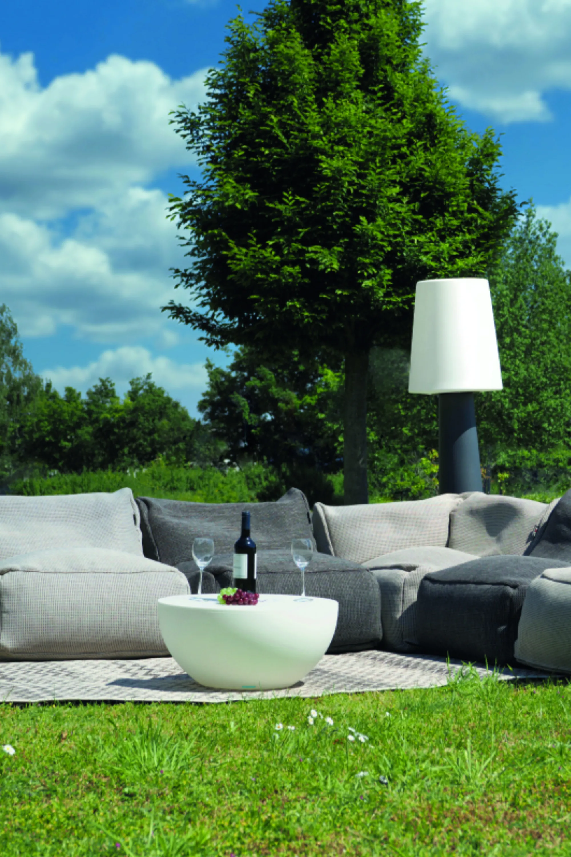 <think> Got it, let's create the alt text. First, identify what's visible. The image shows outdoor furniture on a grassy are…